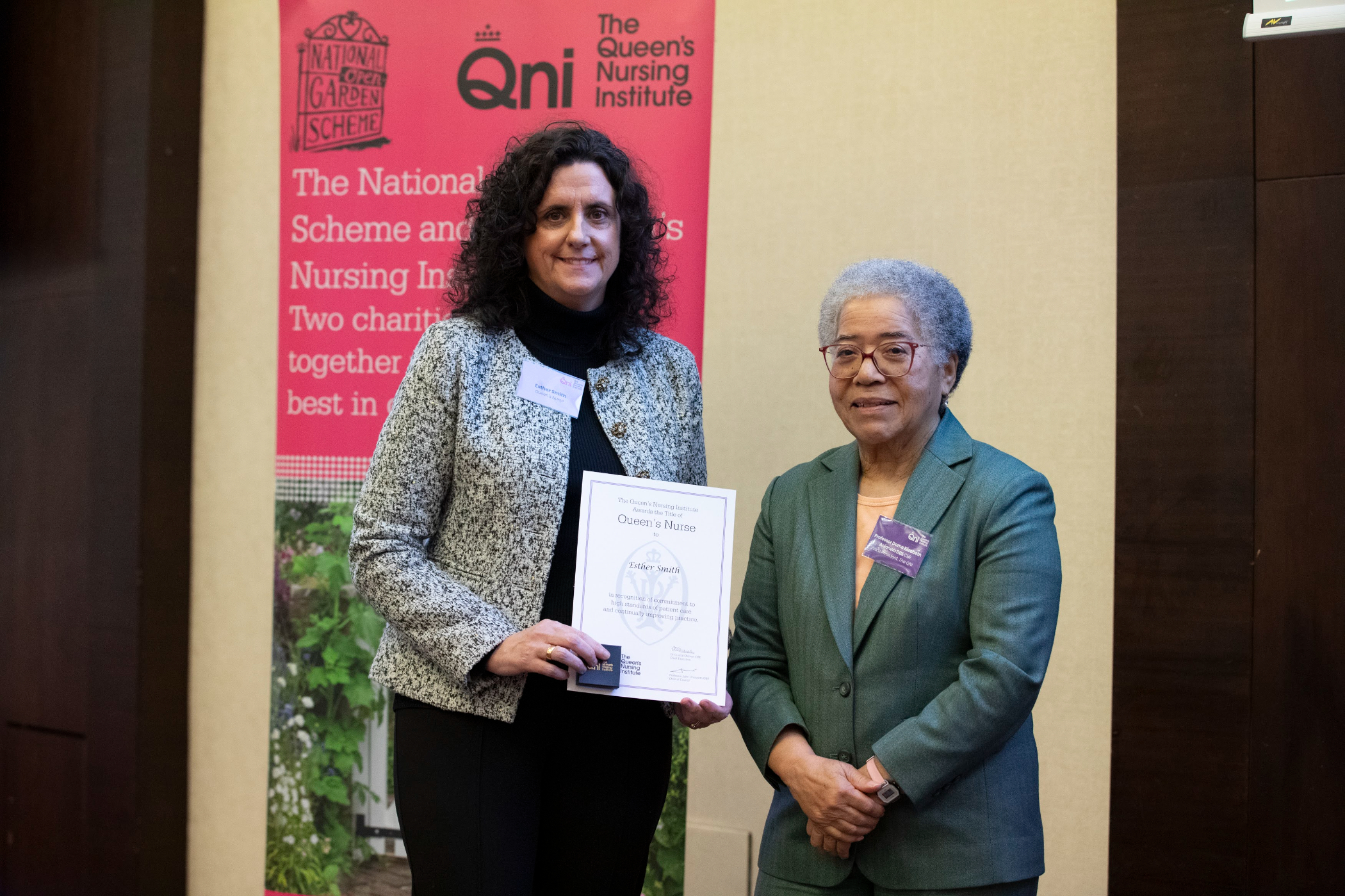 photo of Esther receiving her award from Dame Elizabeth Anionwu.