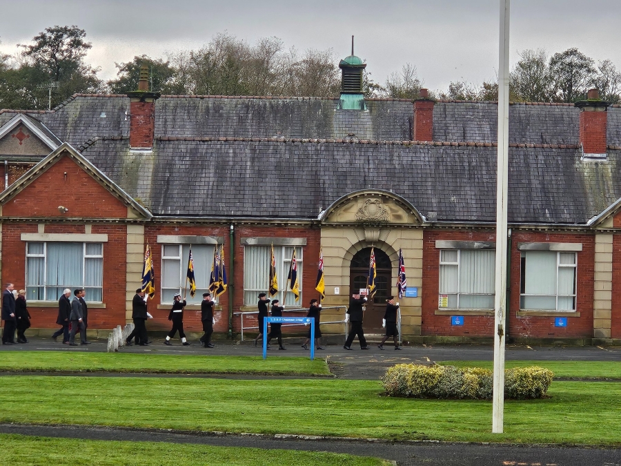 public and members of the armed forces walking on calderstones site at whalley